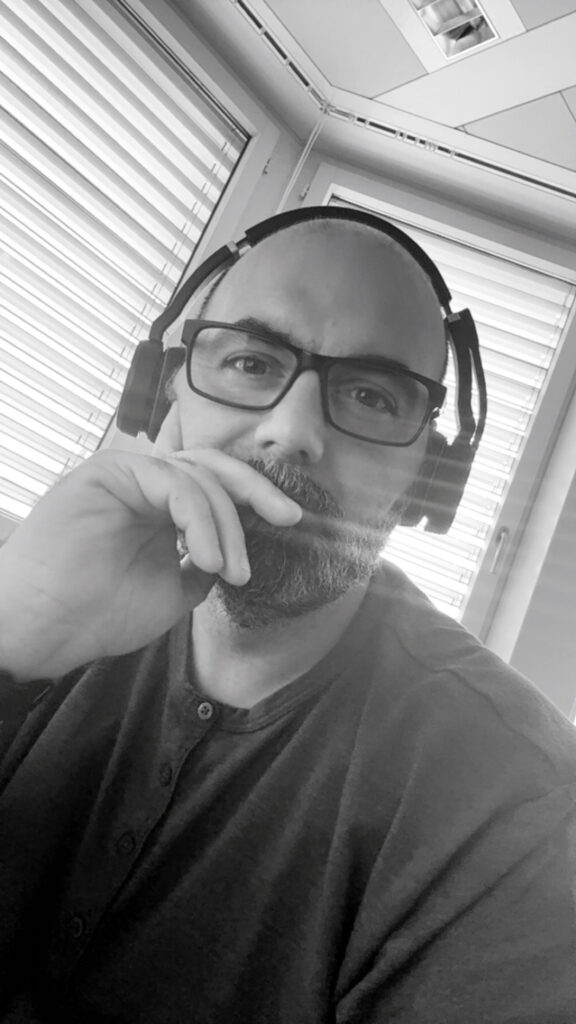 Antonello Daniele Amato mit Kopfhörern im Büro
